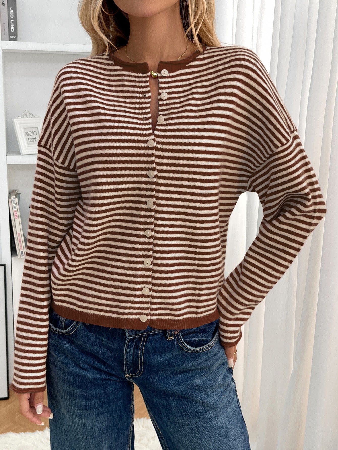 Brown - Women's brown and white striped knit cardigan with button-front closure, styled open over a white crop top and denim jeans.