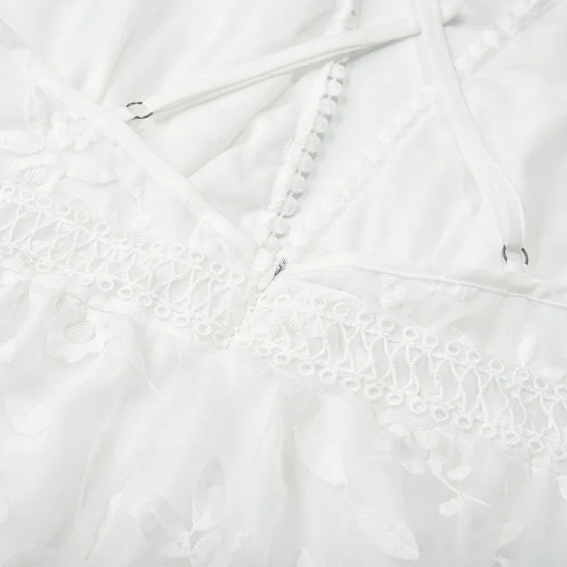 White - White floral appliqué tulle mini dress featuring a deep plunge neckline, crochet-trimmed waist, and a fluid A-line skirt.