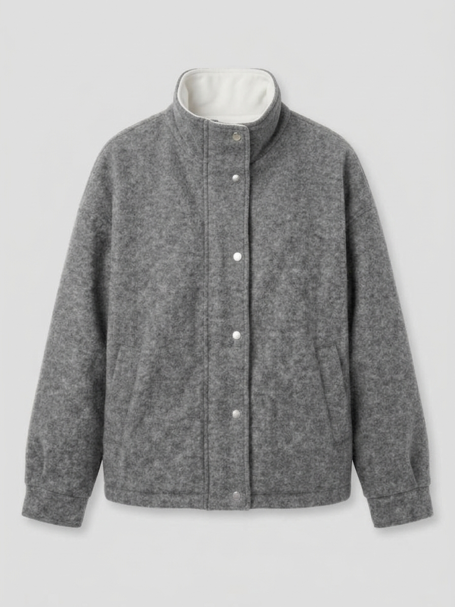 Gray - A woman wearing a dark navy blue textured jacket with a high stand collar lined in contrast cream fleece, featuring a snap-button front closure and a relaxed fit.