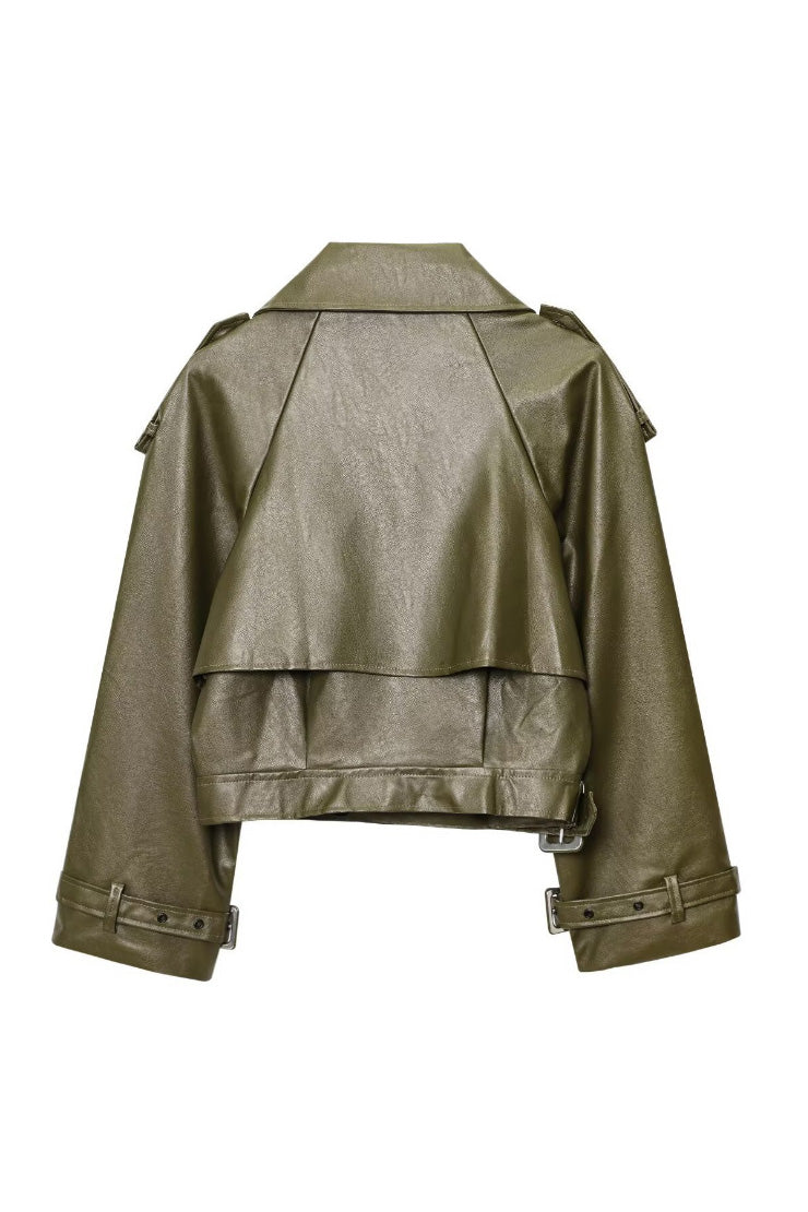 Green - Woman wearing an oversized burgundy faux leather moto jacket with exaggerated shoulders, wide collar, and belted cuffs, styled in a chic city setting.
