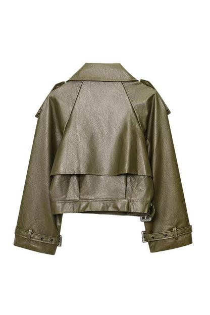 Green - Woman wearing an oversized burgundy faux leather moto jacket with exaggerated shoulders, wide collar, and belted cuffs, styled in a chic city setting.