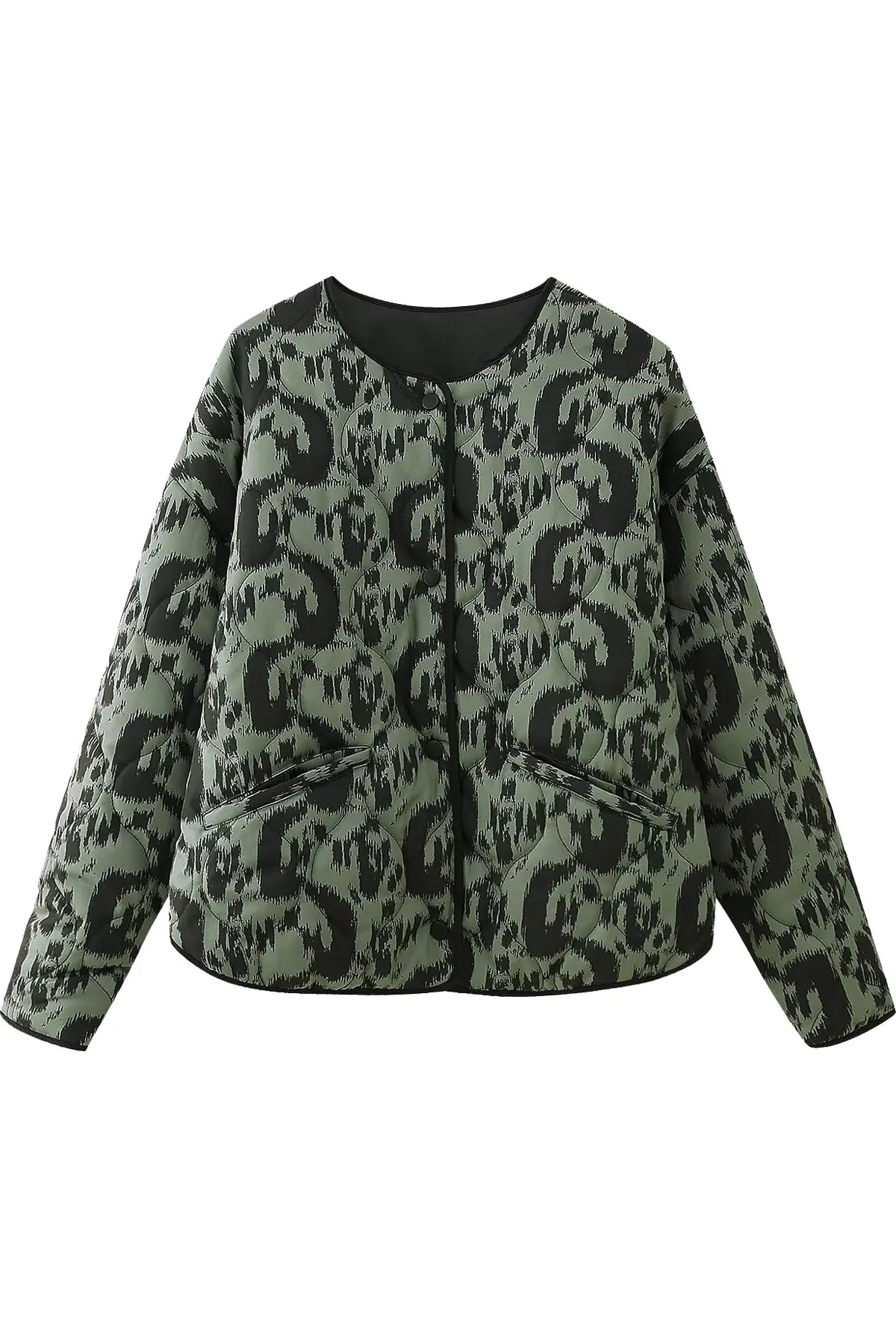 Green - Woman wearing a smart casual quilted collarless jacket with an abstract black and white print, layered over a white top and black bottoms.