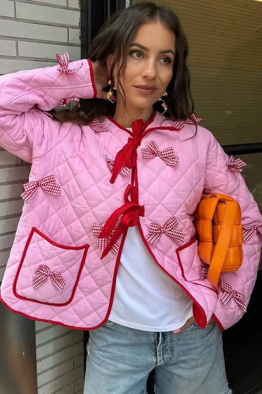 Pink - Women's pink diamond-quilted jacket featuring red contrast trim, red tie-front closures, and decorative red and white gingham bows.