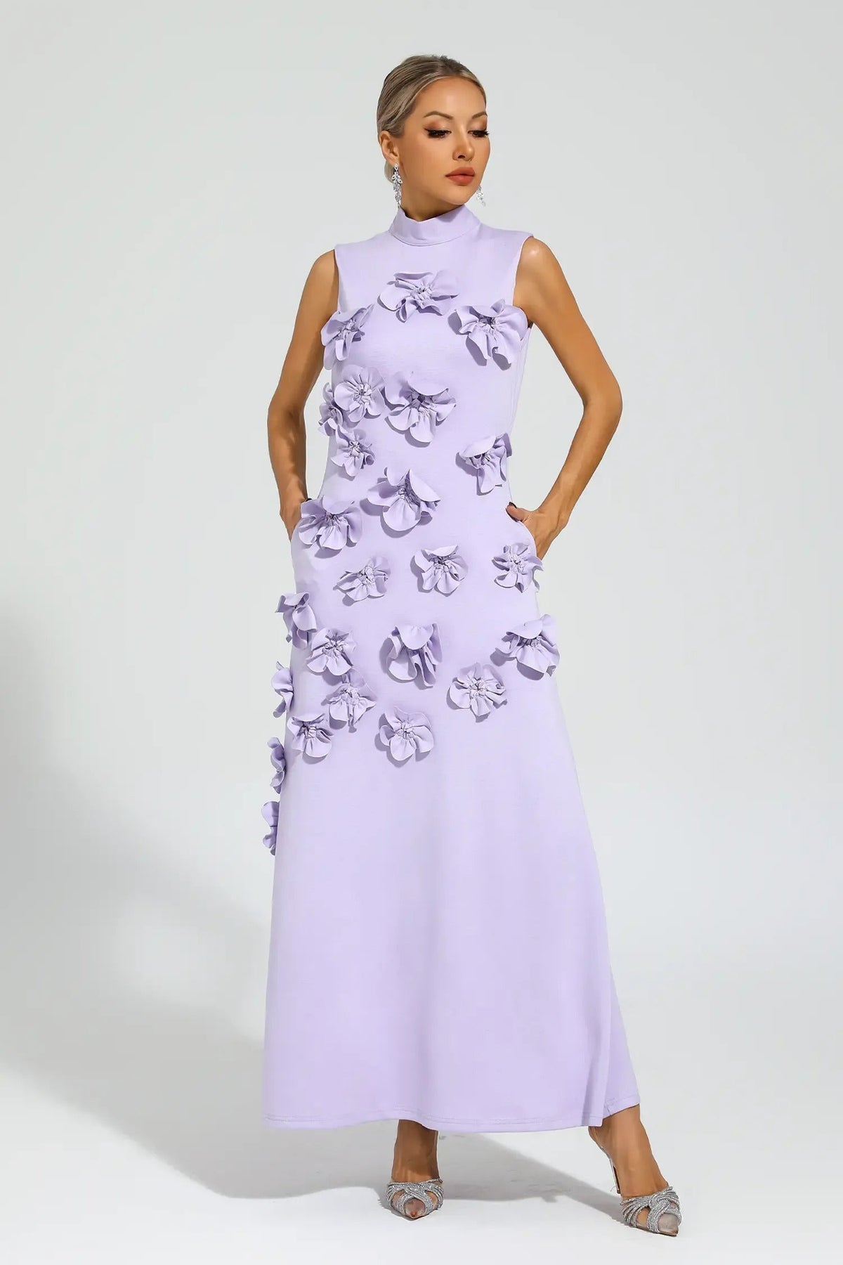 Woman in pink crepe gown with 3D floral appliques