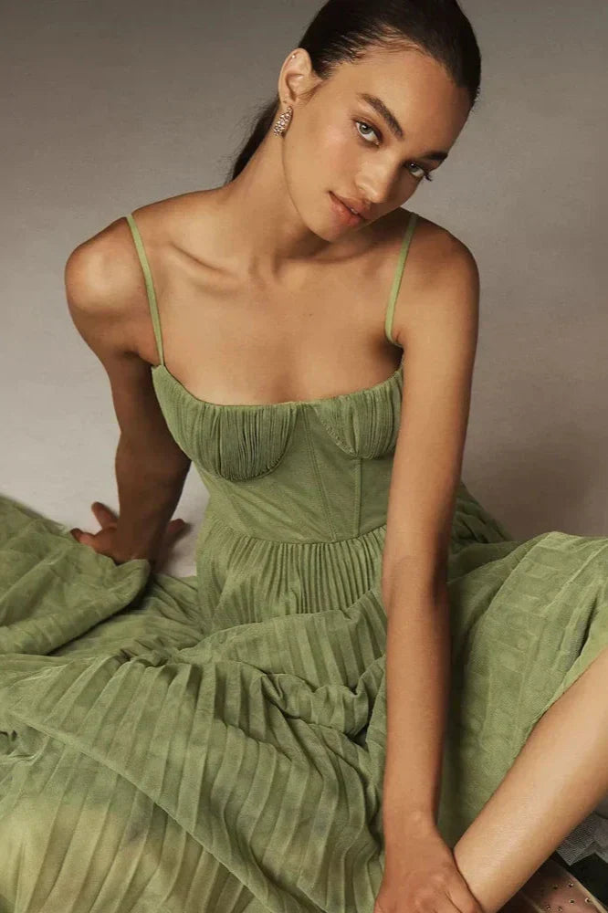 Woman in olive green pleated tulle dress