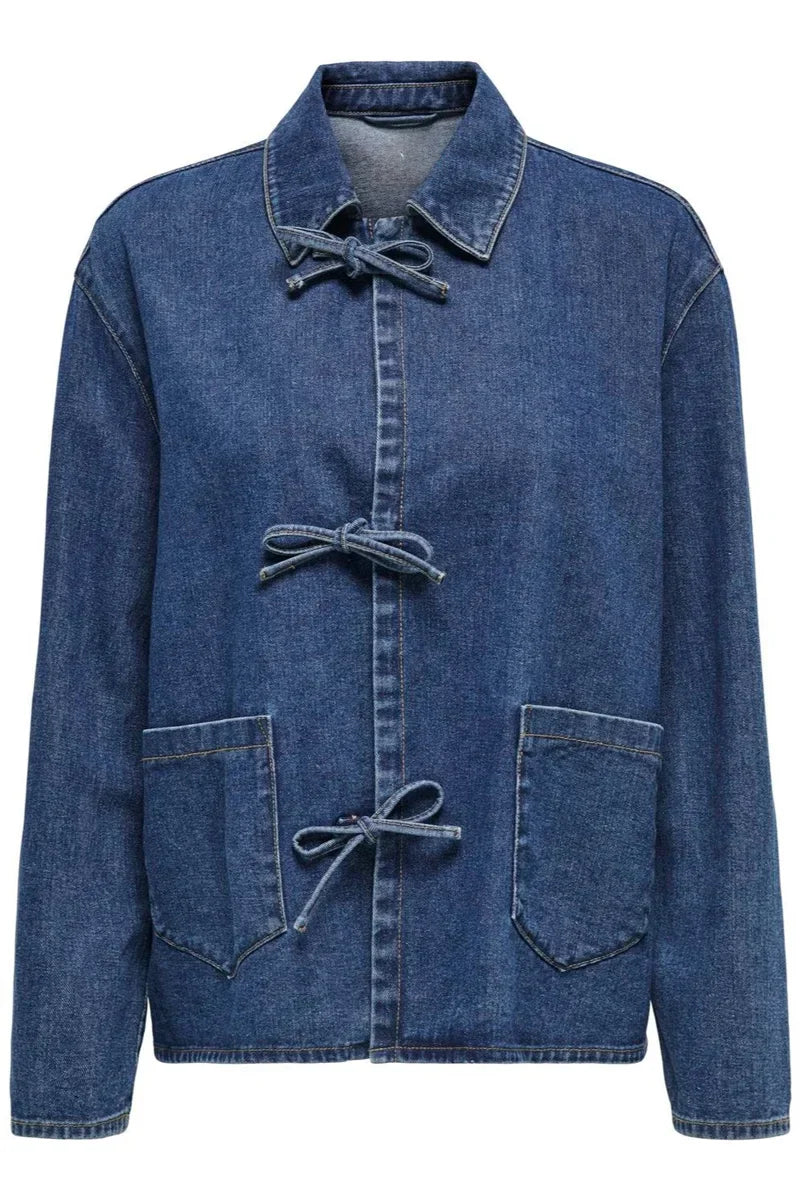 Blue - A woman taking a mirror selfie wearing a blue denim jacket featuring three tie-front closures and patch pockets, paired with wide-leg denim trousers.
