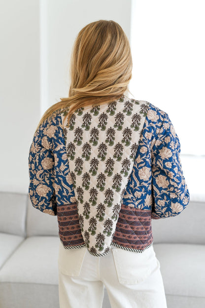 L - Women's quilted open-front jacket featuring a mix of blue and cream floral block prints with contrasting border trims.