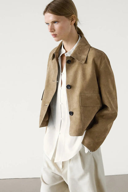 sand - Women's tan suede-look cropped jacket featuring a point collar, large button closures, and two front flap pockets, styled over white tailored shorts.
