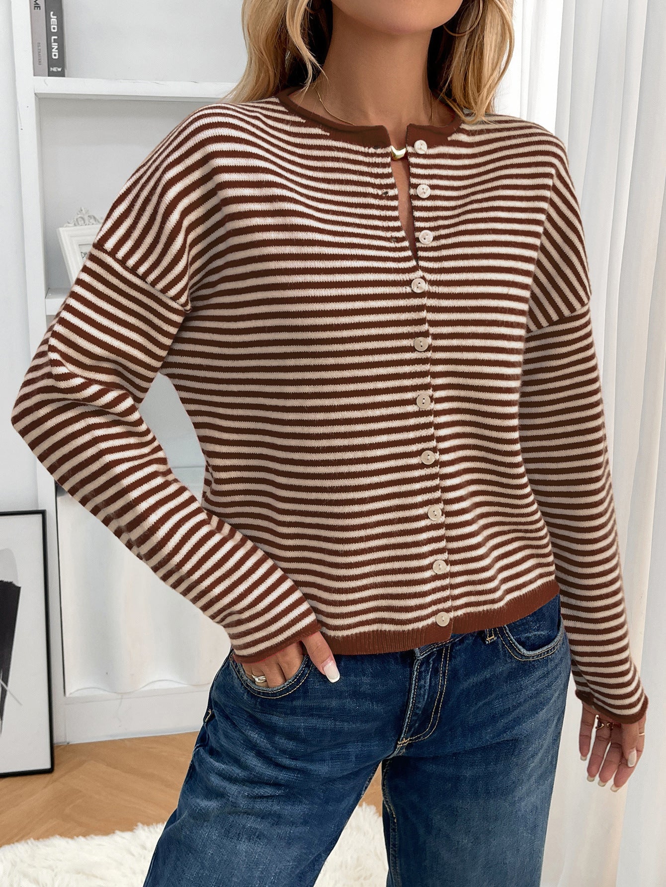 Brown - Women's brown and white striped knit cardigan with button-front closure, styled open over a white crop top and denim jeans.