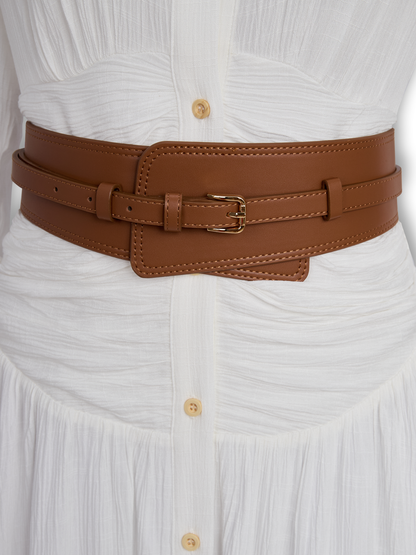 White - A woman wearing a black, long-sleeved, crinkle-textured maxi shirt dress with a button-down front, styled with a tan leather waist belt and brown embroidered cowboy boots.