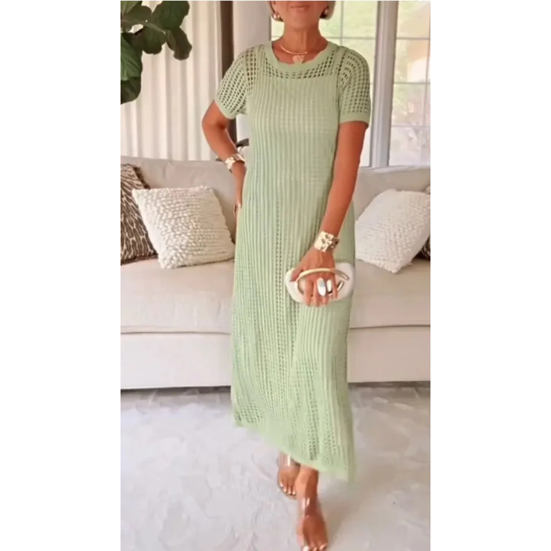 Light Green - A woman wearing a lavender open-knit crochet maxi dress with a crew neck and short sleeves, styled with a beige woven handbag and gold accessories.