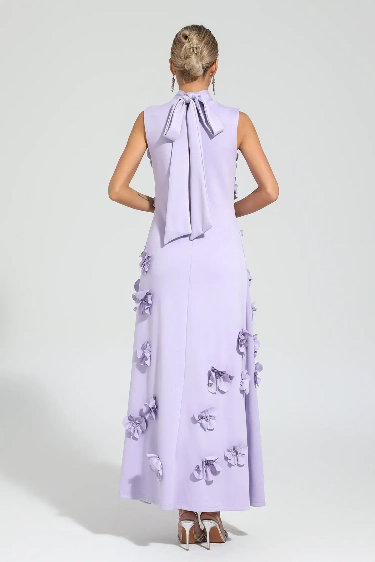 Woman in pink crepe gown with 3D floral appliques