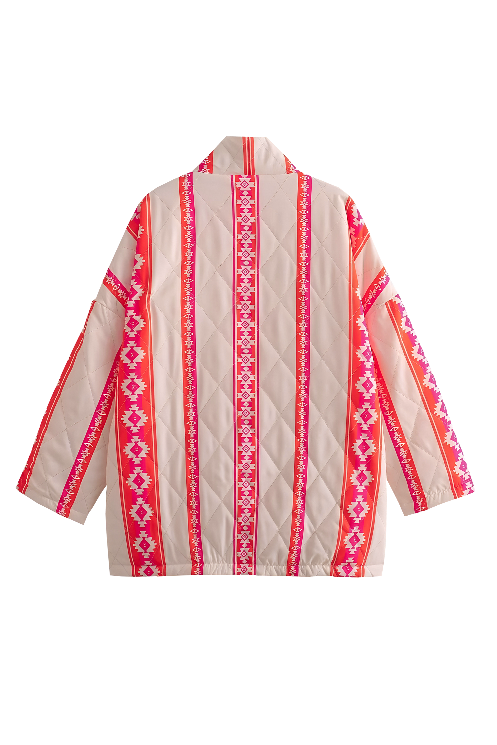 A woman wearing a relaxed, open-front kimono jacket featuring a vibrant pink and orange geometric Aztec print over a cream base, styled over a crochet crop top and shorts.