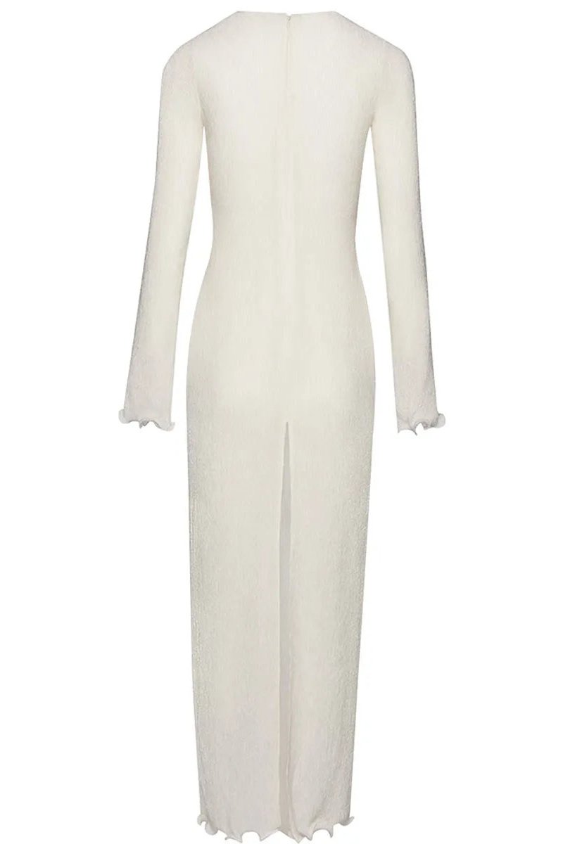 White - A woman wearing a long-sleeved, white ribbed knit maxi dress featuring a deep plunging neckline decorated with large 3D floral appliqués.