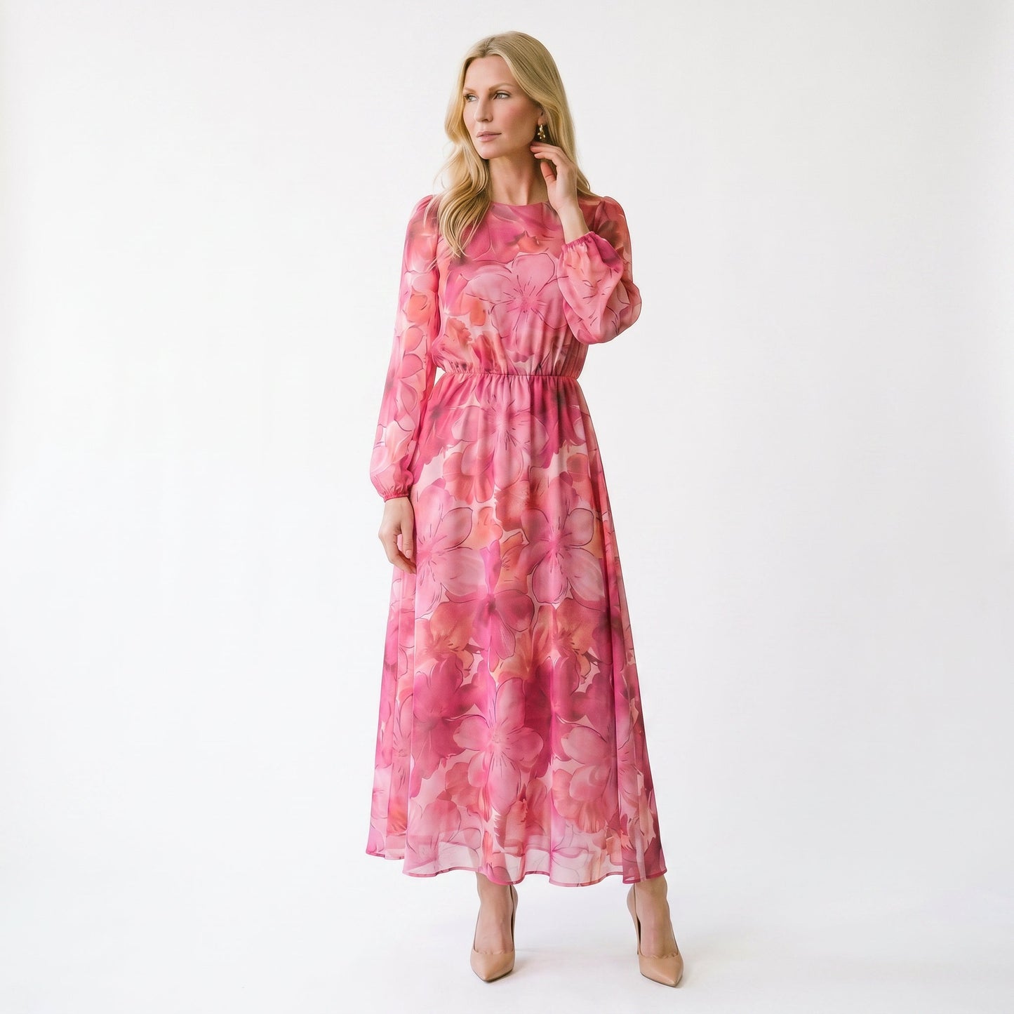 Pink - A woman stands wearing a blue and purple floral print chiffon midi dress with long sheer puff sleeves, a high neckline, and an A-line skirt, holding a gold clutch.