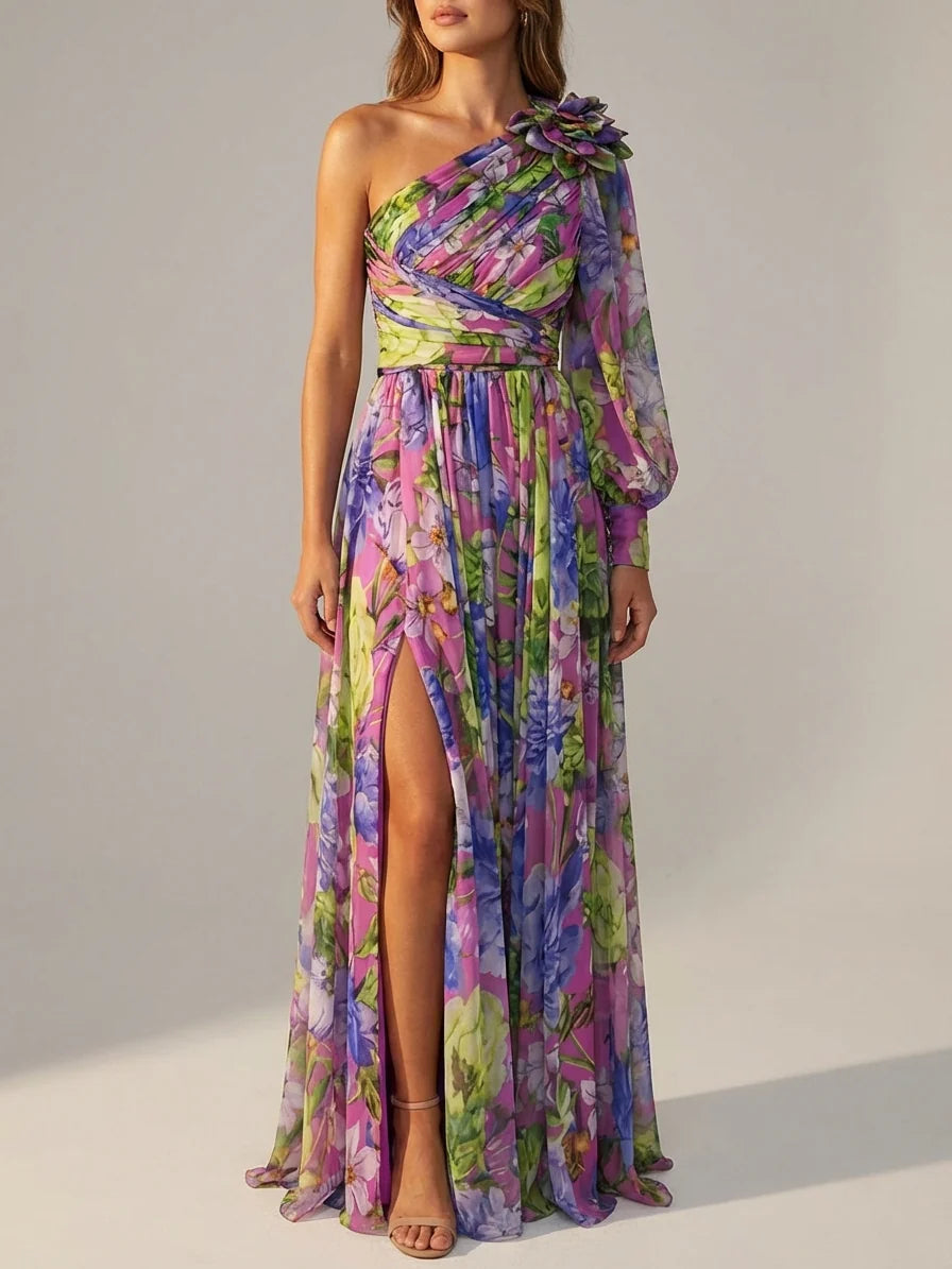 Purple - A woman wearing a vibrant floral print chiffon one-shoulder maxi dress with a single long balloon sleeve, ruched bodice, and a high leg slit.