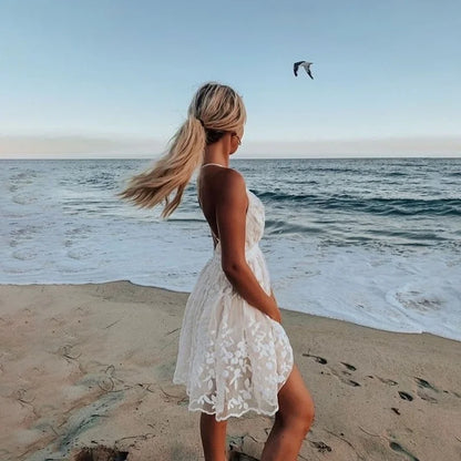 White - White floral appliqué tulle mini dress featuring a deep plunge neckline, crochet-trimmed waist, and a fluid A-line skirt.