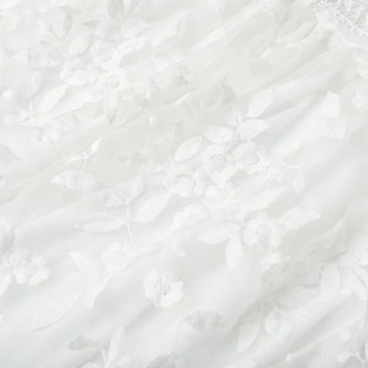 White - White floral appliqué tulle mini dress featuring a deep plunge neckline, crochet-trimmed waist, and a fluid A-line skirt.