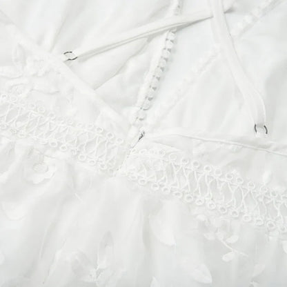 White - White floral appliqué tulle mini dress featuring a deep plunge neckline, crochet-trimmed waist, and a fluid A-line skirt.