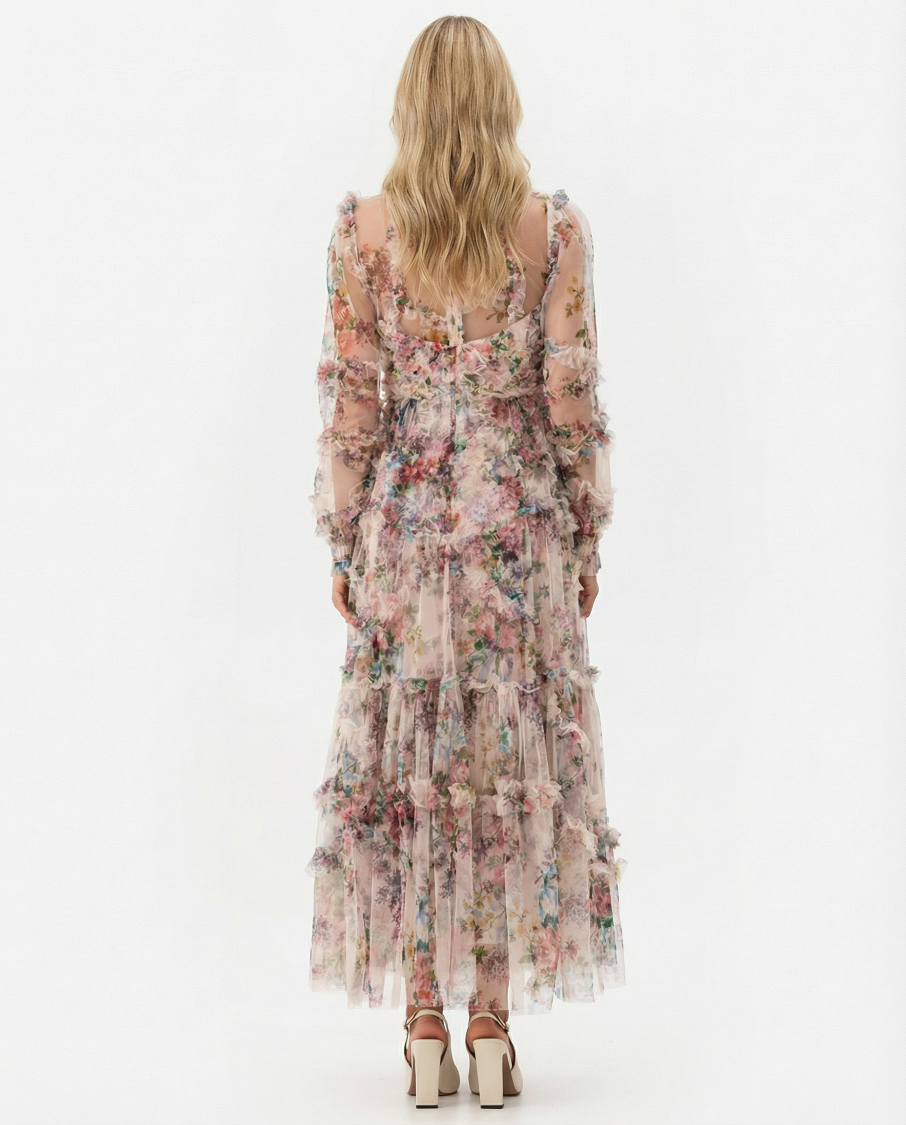 Apricot - A model wearing a high-neck, long-sleeved maxi dress in black tulle with a vibrant multi-coloured floral print, featuring tiered ruffles and sheer sleeves.
