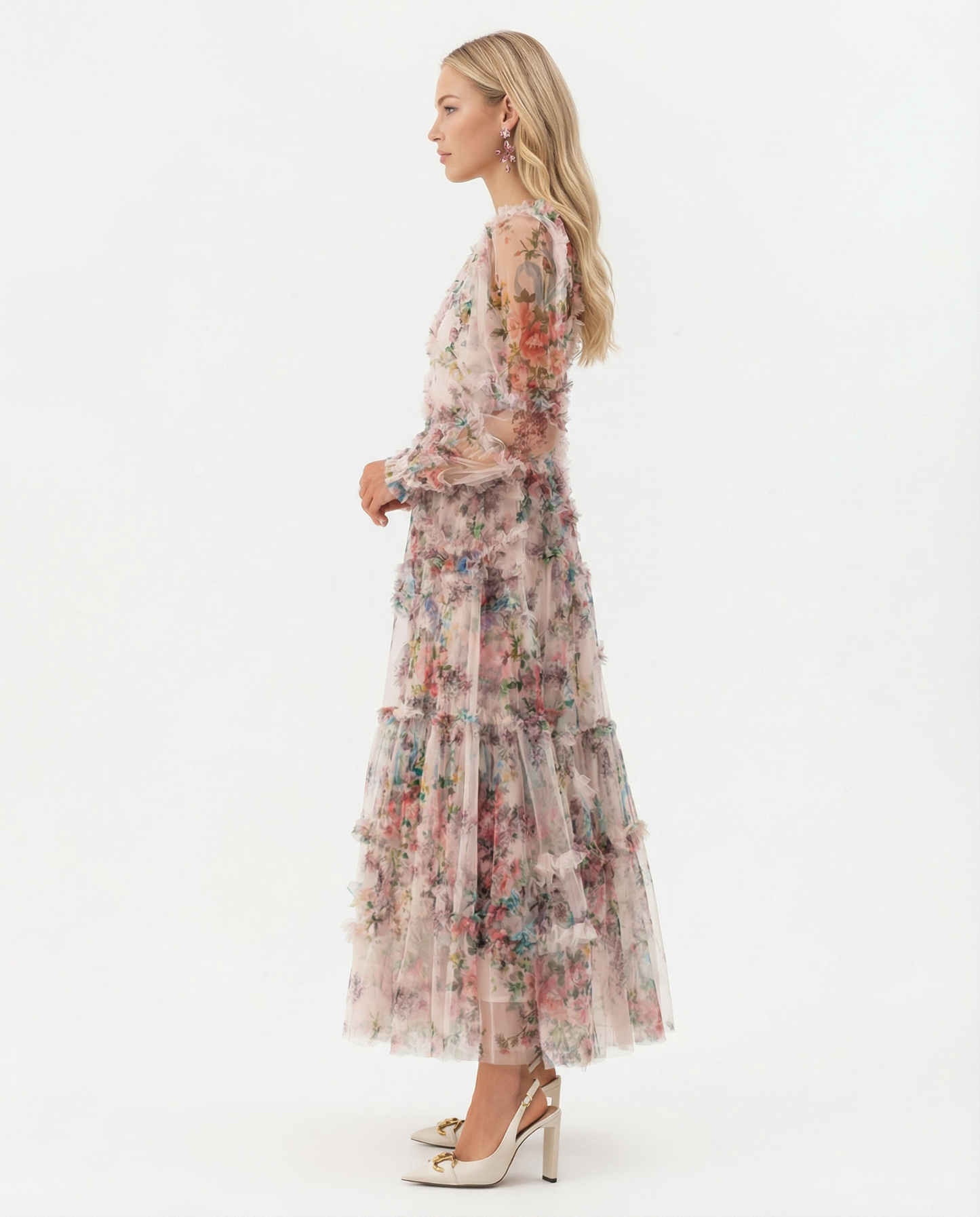 Apricot - A model wearing a high-neck, long-sleeved maxi dress in black tulle with a vibrant multi-coloured floral print, featuring tiered ruffles and sheer sleeves.