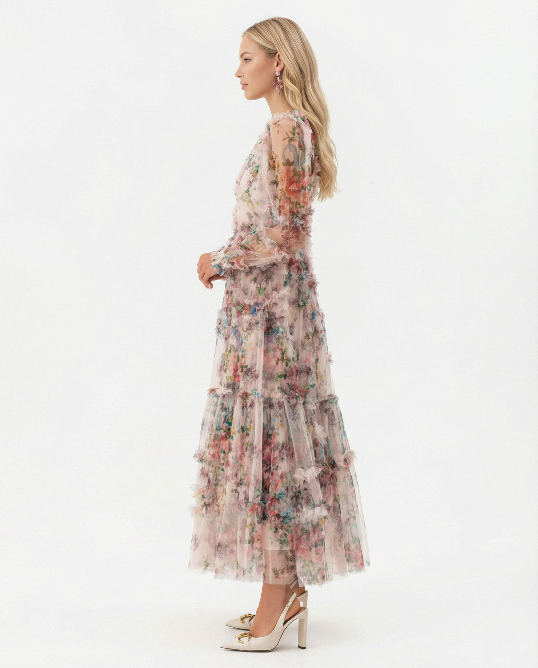 Apricot - A model wearing a high-neck, long-sleeved maxi dress in black tulle with a vibrant multi-coloured floral print, featuring tiered ruffles and sheer sleeves.