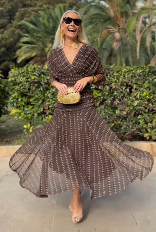 Brown - Women's resort-style maxi dress featuring a V-neckline, ruched waist, sheer three-quarter sleeves, and a flowing skirt with a geometric diamond pattern.