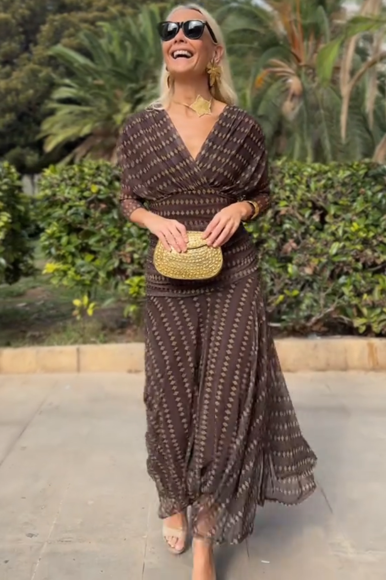 Brown - Women's resort-style maxi dress featuring a V-neckline, ruched waist, sheer three-quarter sleeves, and a flowing skirt with a geometric diamond pattern.