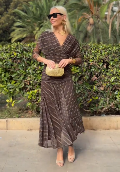 Brown - Women's resort-style maxi dress featuring a V-neckline, ruched waist, sheer three-quarter sleeves, and a flowing skirt with a geometric diamond pattern.
