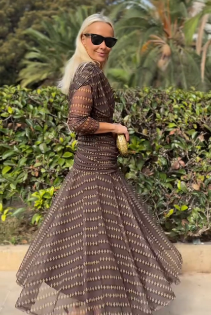 Brown - Women's resort-style maxi dress featuring a V-neckline, ruched waist, sheer three-quarter sleeves, and a flowing skirt with a geometric diamond pattern.