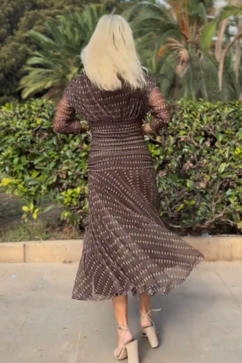 Brown - Women's resort-style maxi dress featuring a V-neckline, ruched waist, sheer three-quarter sleeves, and a flowing skirt with a geometric diamond pattern.