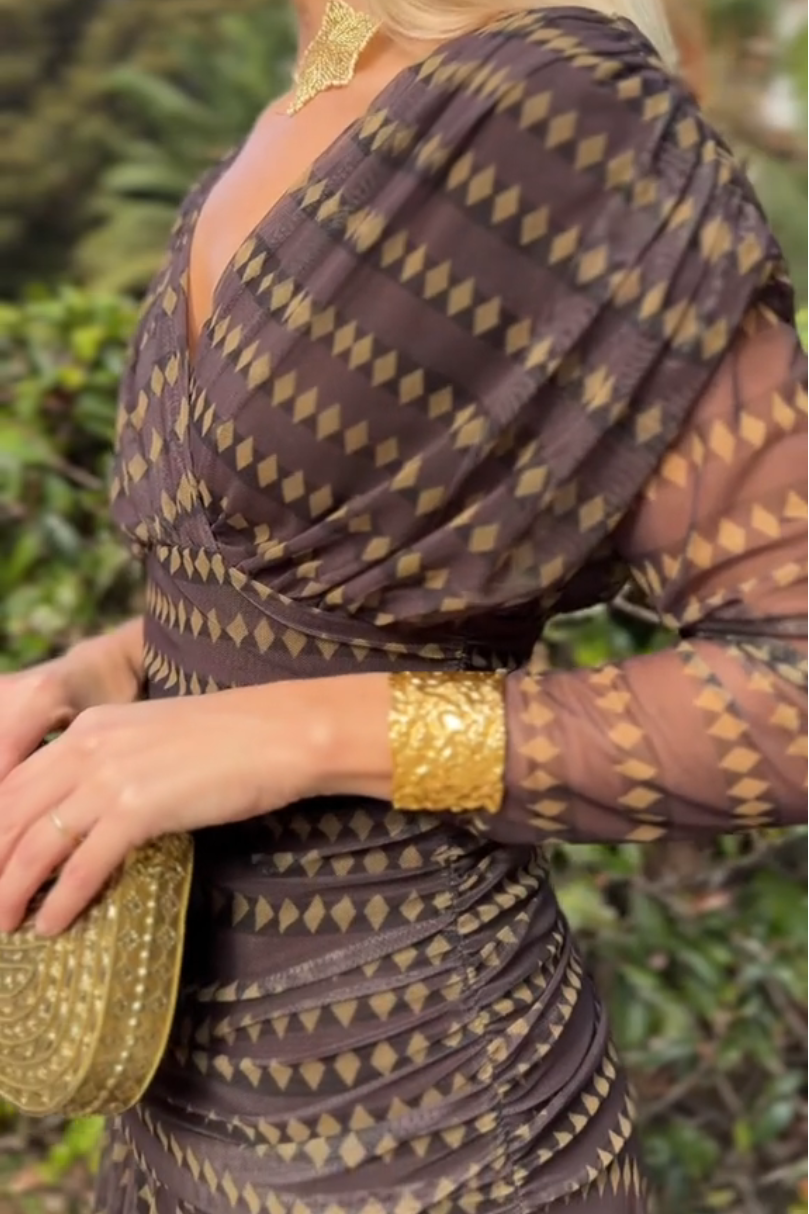 Brown - Women's resort-style maxi dress featuring a V-neckline, ruched waist, sheer three-quarter sleeves, and a flowing skirt with a geometric diamond pattern.