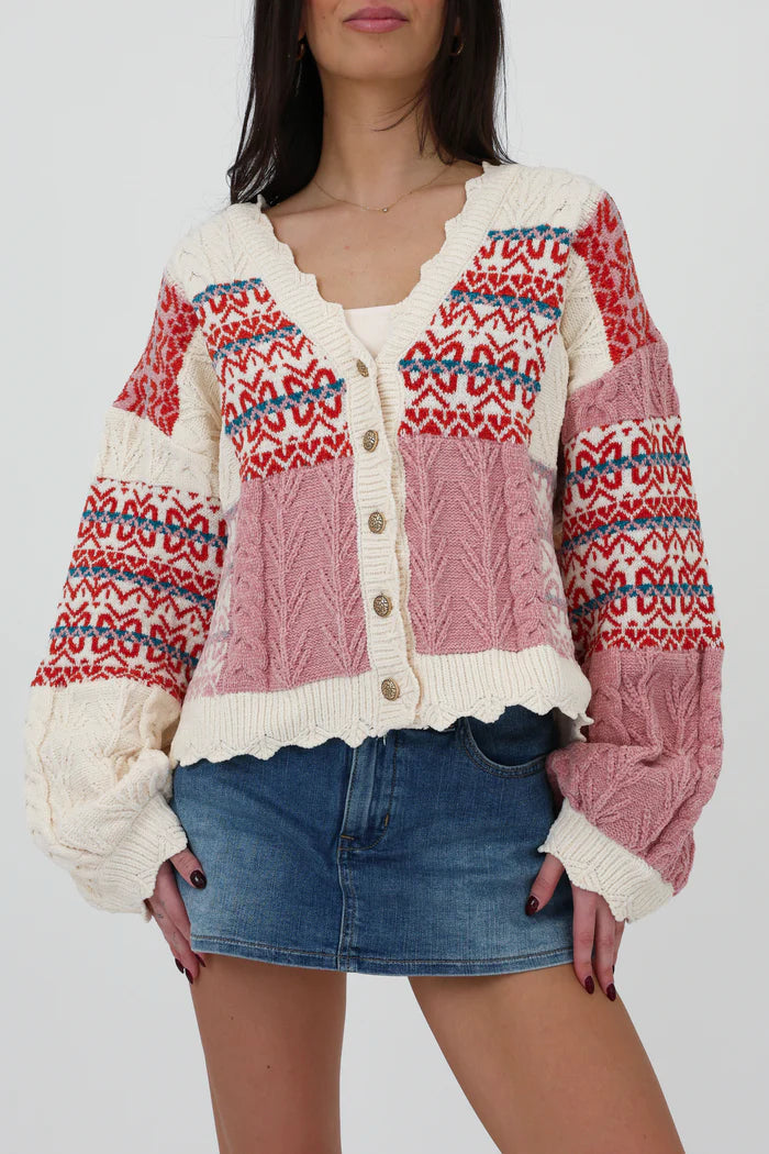 Multi-color - Women's chunky V-neck cardigan featuring a patchwork design of pink, red, and cream Fair Isle patterns and cable knit textures, finished with scalloped edges and metallic buttons.