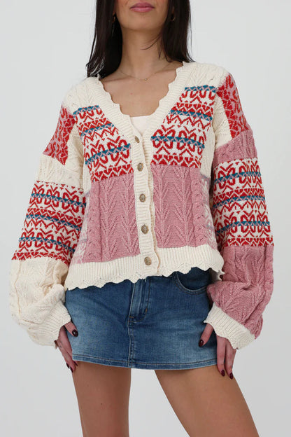 Multi-color - Women's chunky V-neck cardigan featuring a patchwork design of pink, red, and cream Fair Isle patterns and cable knit textures, finished with scalloped edges and metallic buttons.