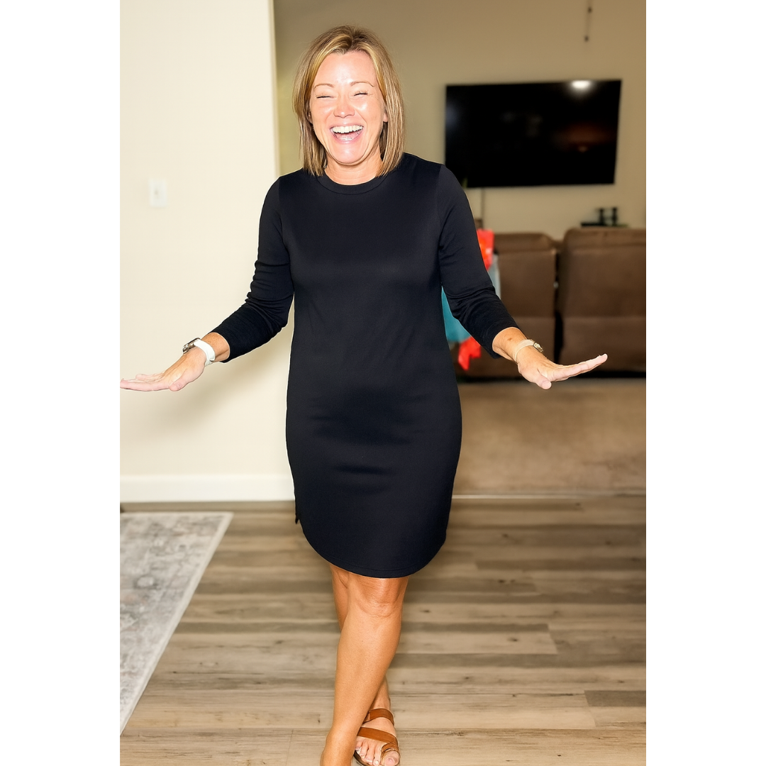 White - Woman wearing a solid long sleeve jersey shift mini dress with side hem slits