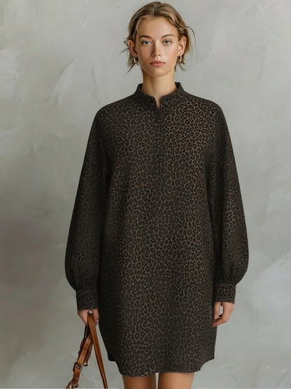 Brown - A model wears a relaxed-fit, long-sleeve mini shirt dress featuring a dark brown leopard print pattern, styled with a point collar and partial button placket.