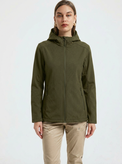 Green - A woman wearing a structured olive green matte technical hooded jacket with a front zip closure, panelled seam detailing, and zippered pockets, paired with beige trousers.