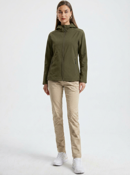 Green - A woman wearing a structured olive green matte technical hooded jacket with a front zip closure, panelled seam detailing, and zippered pockets, paired with beige trousers.