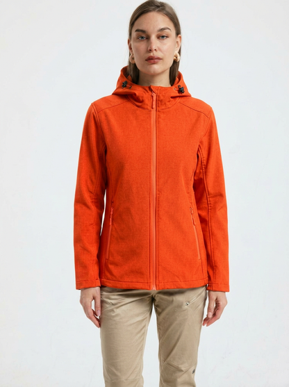 Orange - A woman wearing a structured olive green matte technical hooded jacket with a front zip closure, panelled seam detailing, and zippered pockets, paired with beige trousers.