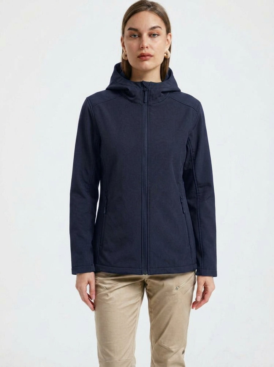 Navy - A woman wearing a structured olive green matte technical hooded jacket with a front zip closure, panelled seam detailing, and zippered pockets, paired with beige trousers.