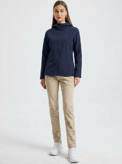 Navy - A woman wearing a structured olive green matte technical hooded jacket with a front zip closure, panelled seam detailing, and zippered pockets, paired with beige trousers.