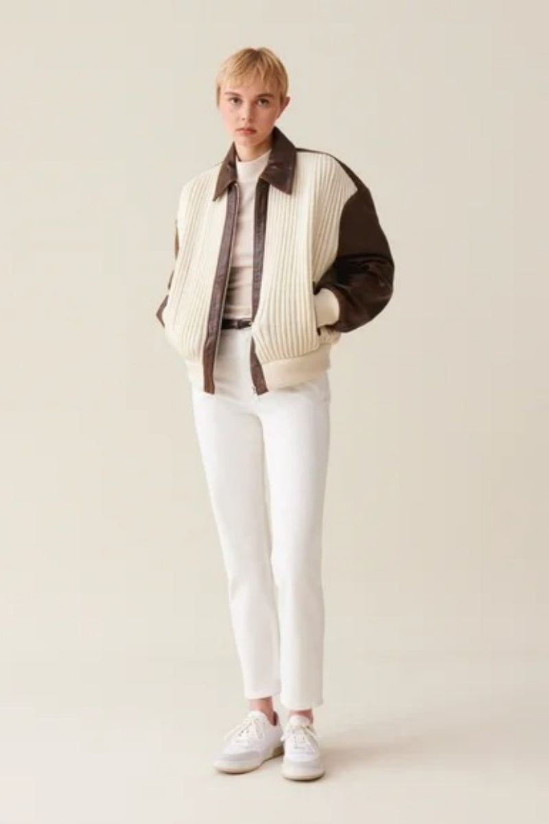 White - Women's oversized bomber jacket featuring a cream ribbed knit body with contrasting brown faux leather sleeves, collar, and zip placket.