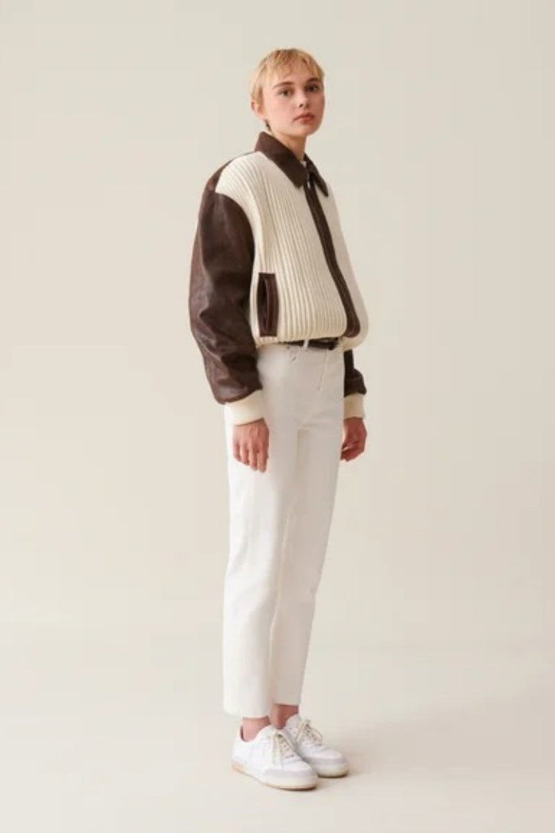 White - Women's oversized bomber jacket featuring a cream ribbed knit body with contrasting brown faux leather sleeves, collar, and zip placket.