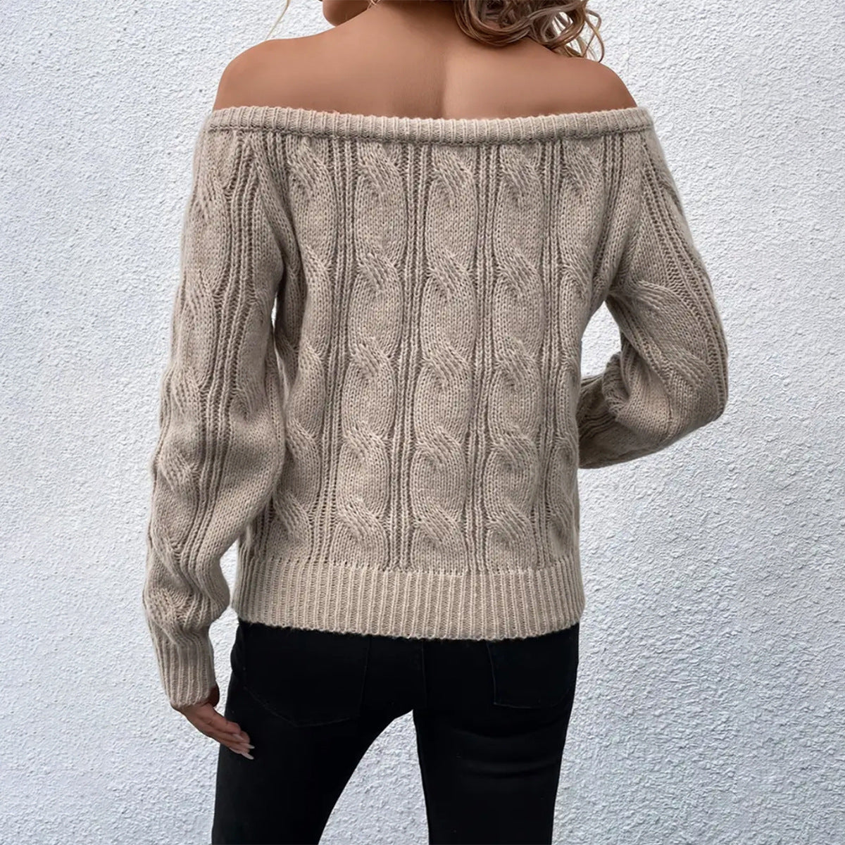 Khaki - Women's off-the-shoulder cable knit sweater featuring long sleeves and ribbed trims, styled with dark pants.