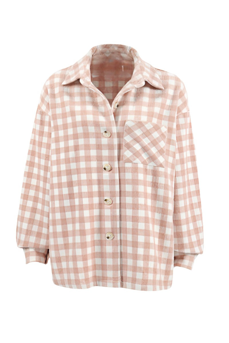 A woman taking a mirror selfie wearing an oversized, light pink and white plaid shacket over a white crop top and light wash denim jeans.