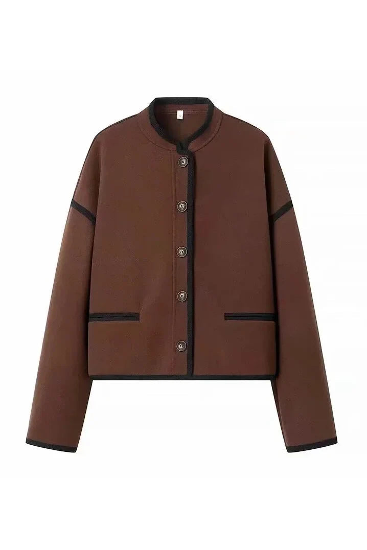 Brown - A woman wearing a dark brown, heavyweight textured cropped jacket with an oversized fit, button-front closure, and dropped shoulders, styled casually with dark denim.