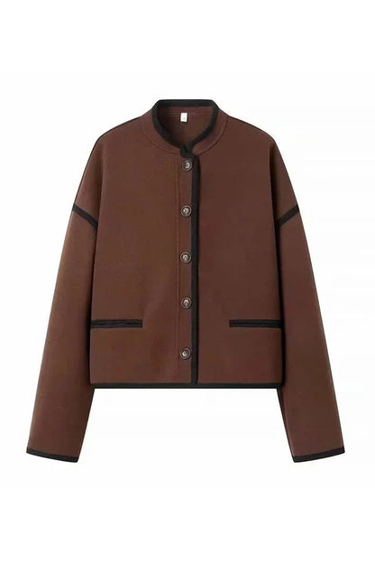Brown - A woman wearing a dark brown, heavyweight textured cropped jacket with an oversized fit, button-front closure, and dropped shoulders, styled casually with dark denim.