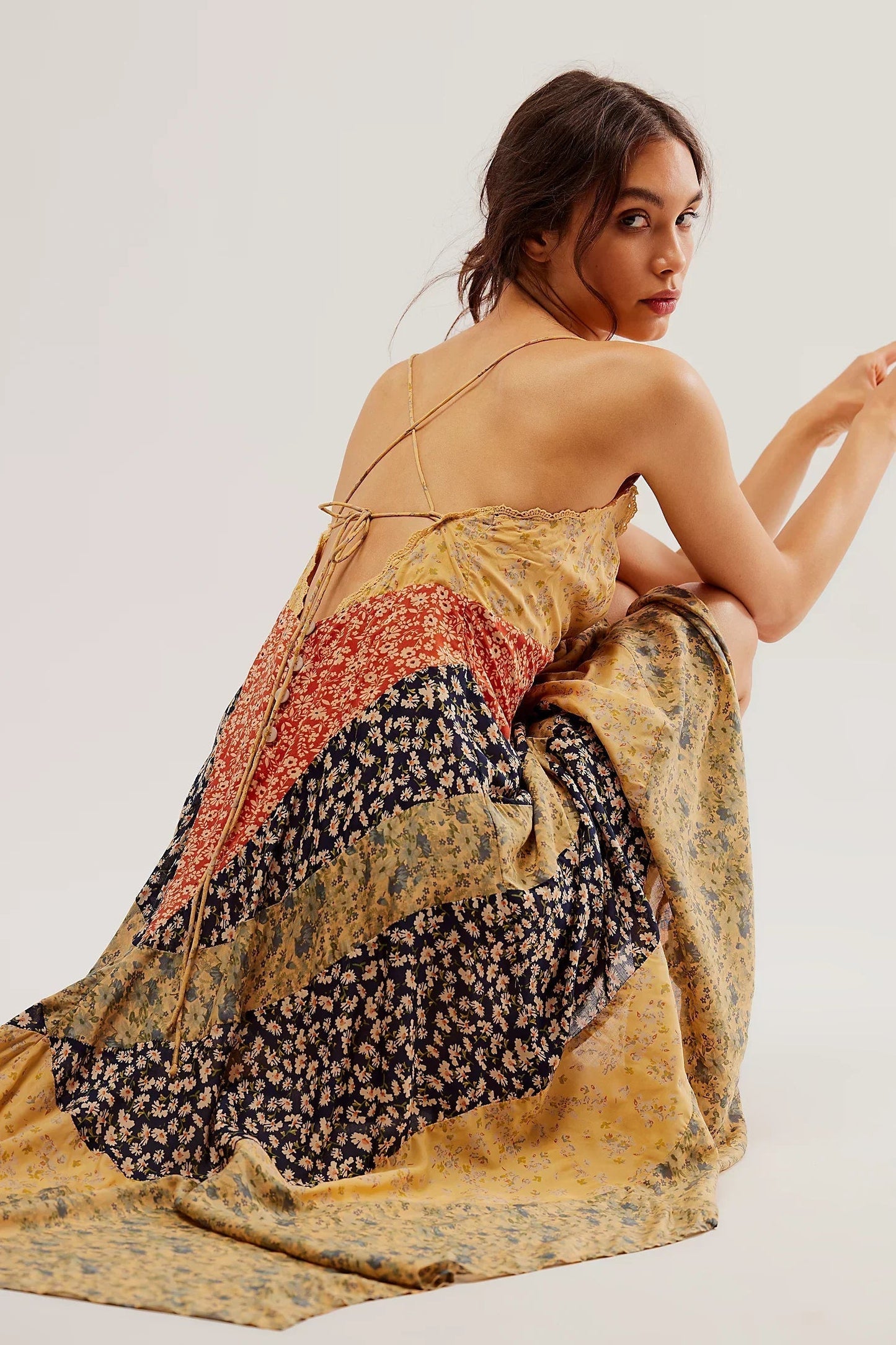 Multi - A model wearing a patchwork floral chiffon maxi dress with a lace-trimmed V-neckline and an asymmetric handkerchief hem.