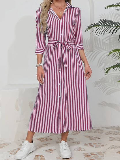 Black - Woman wearing a striped poplin midi shirt dress with 3/4 sleeves, a collared neckline, and a tie waist, styled with white trainers.