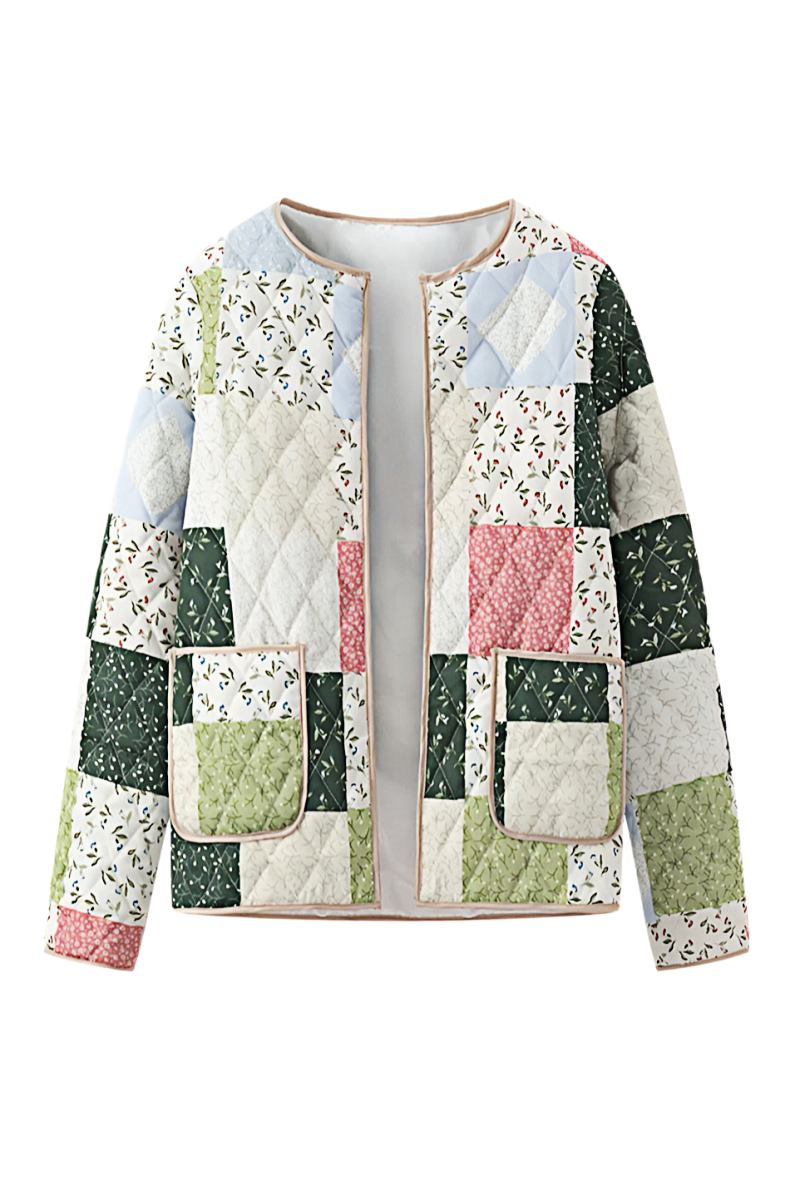 A woman wearing a quilted patchwork jacket with floral and solid panels, styled over a beige shirt and pink textured mini skirt.
